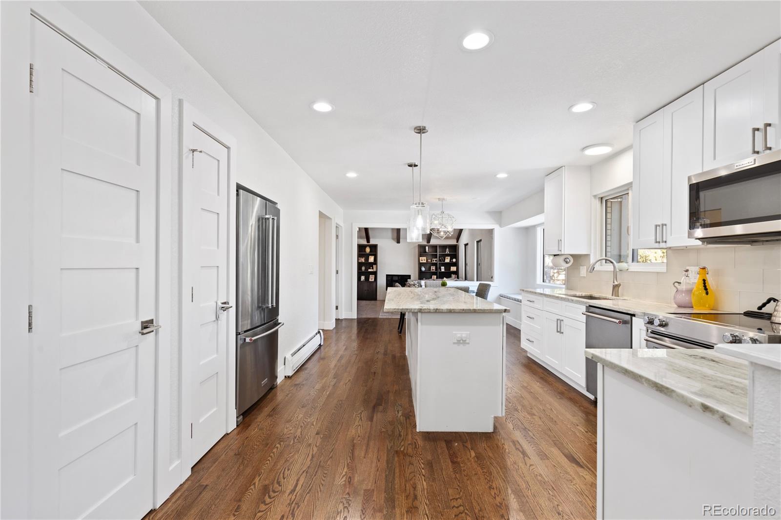 3764 South Niagara Way Denver, CO 80237 - Photo 9 of 50 a kitchen with white cabinets and stainless steel appliances