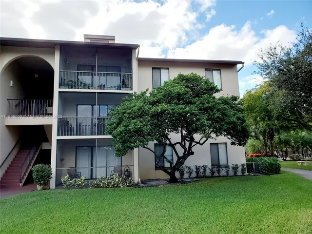 a front view of a house with a garden and plants