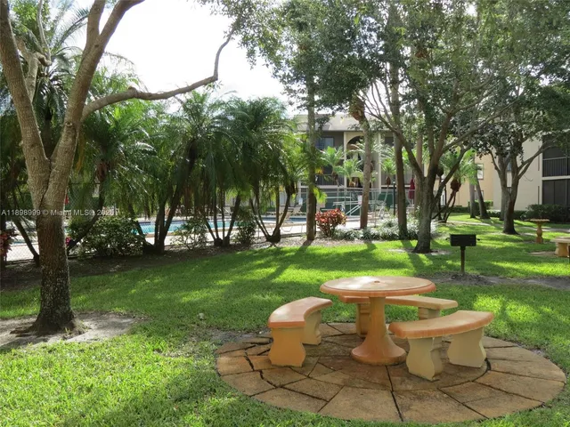 a view of a table and chairs in the garden