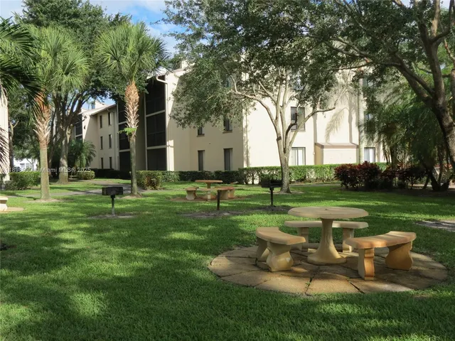 a garden with trees and grass