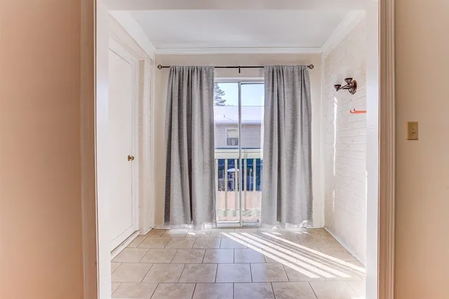 a view of a hallway with windows and entryway