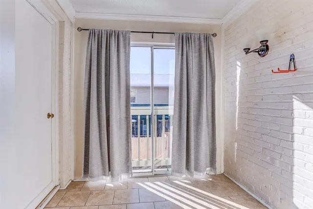 a view of a bathroom with a shower and a window