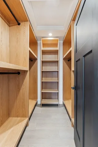 a view of walk in closet with empty racks