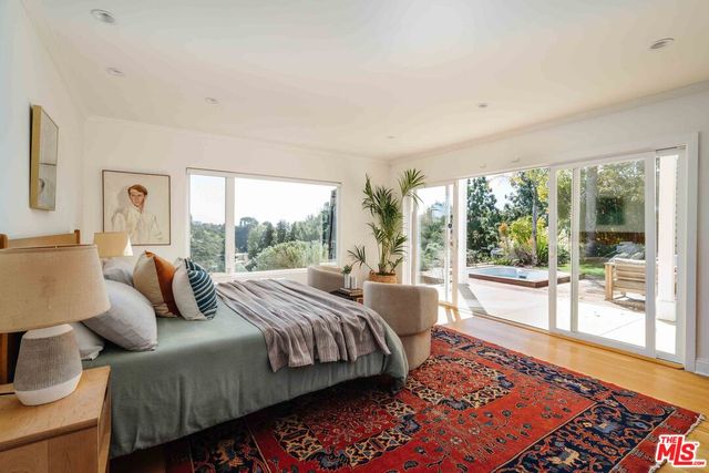 a bedroom with a bed and glass window