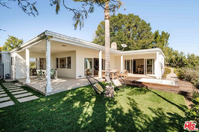 a view of a patio with a table and chairs
