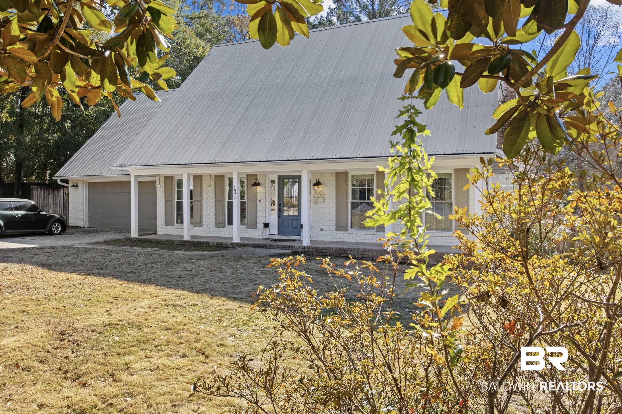 131 Marikesh Drive Daphne, AL 36526 - Photo 23 of 29 View of front of home with a garage, a porch, and a front lawn