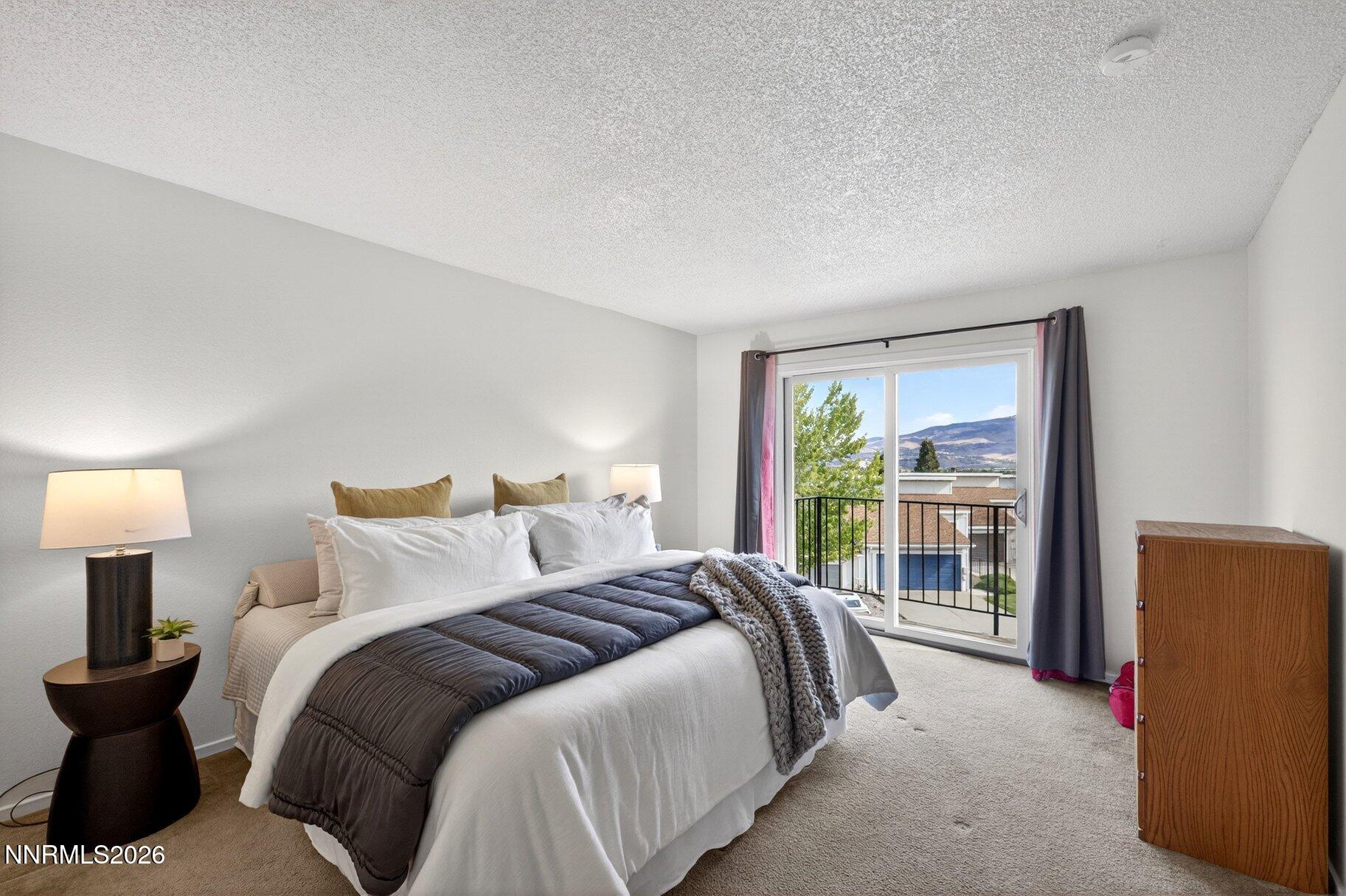 3415 Balboa Drive Reno, NV 89503 - Photo 16 of 61 a bedroom with a bed and a lamp next to a window