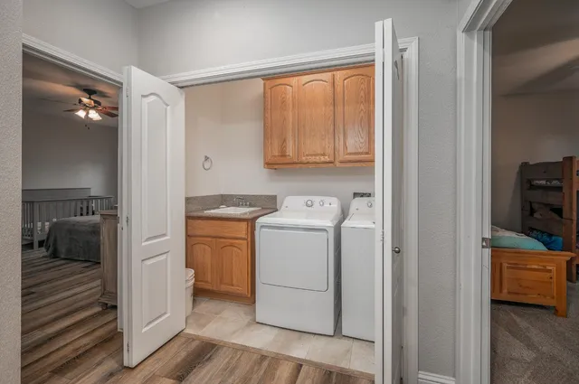 a view of washer and dryer with wooden floor
