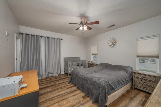 a bedroom with a bed and a chandelier
