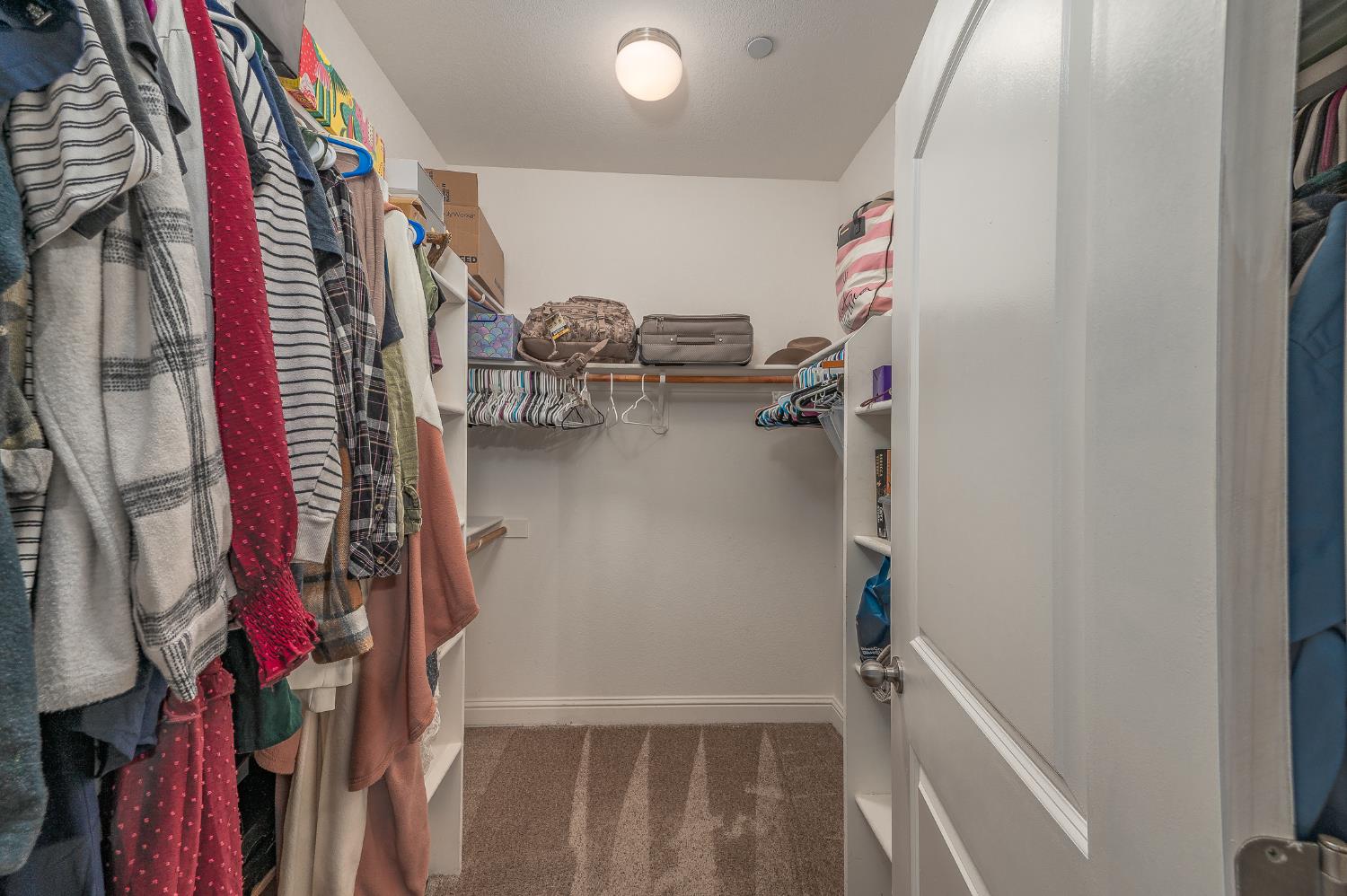 4530 Maximus Road Denair, CA 95316 - Photo 28 of 36 a view of walk in closet with clothes and shoes