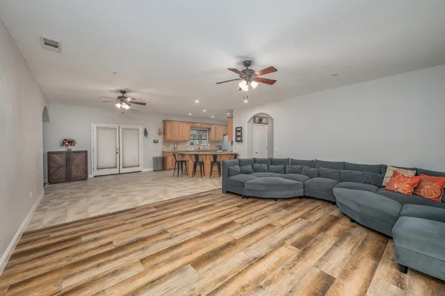 a living room with furniture and a chandelier
