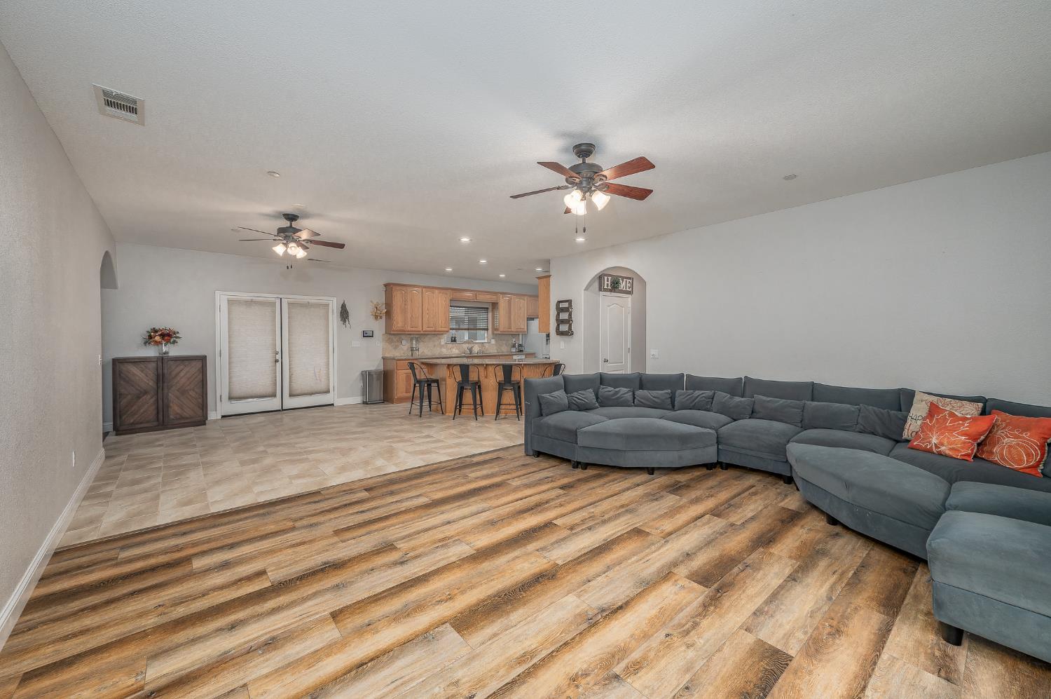 4530 Maximus Road Denair, CA 95316 - Photo 7 of 36 a living room with furniture and a chandelier