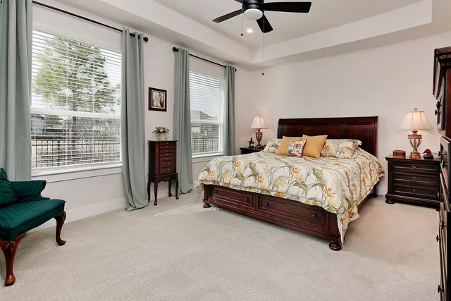 a bedroom with a bed and large window