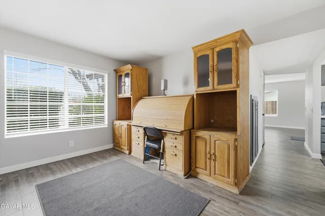a view of a livingroom with furniture and a window