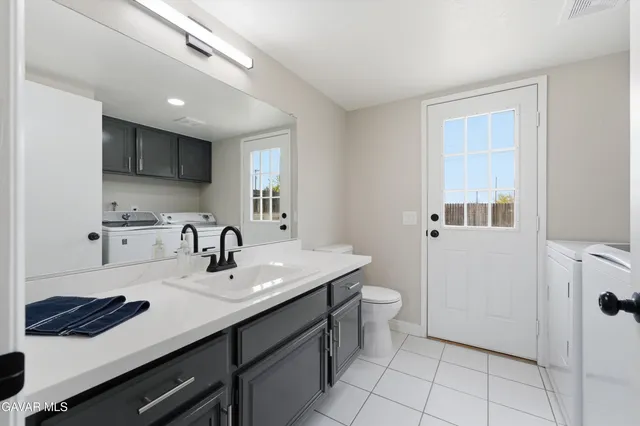 a kitchen with a sink a stove a refrigerator and cabinets