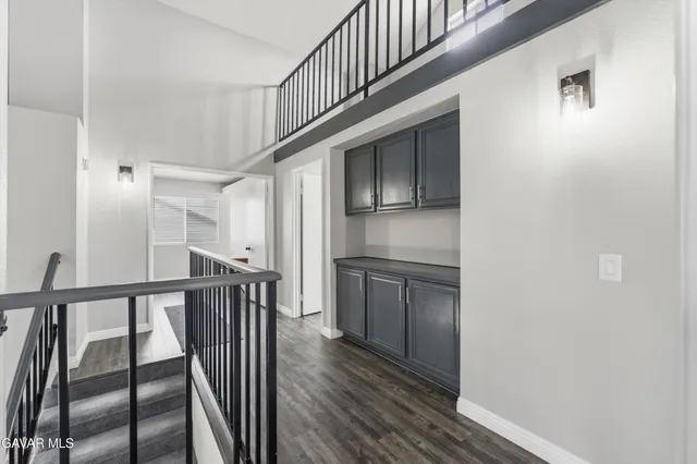 a kitchen with a refrigerator and white cabinets