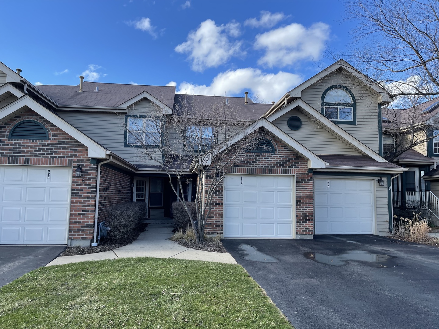 922 Ridgefield Lane Wheeling, IL 60090 - Photo 1 of 1 a front view of a house with a yard and garage
