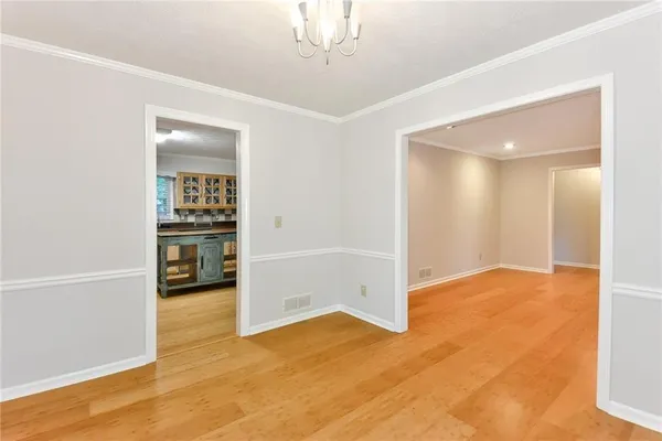 an empty room with cabinet and mirrors