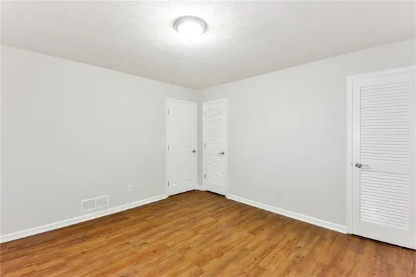 an empty room with wooden floor