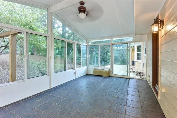 a view of an entryway with floor to ceiling windows and stairs