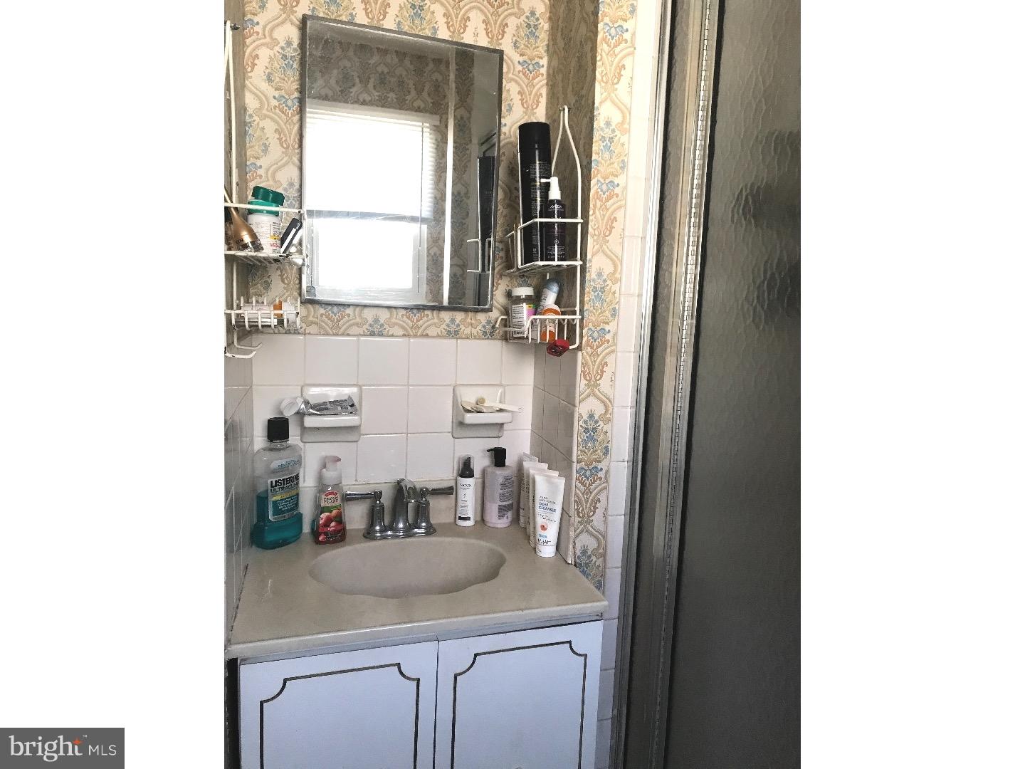 15213 Wayside Road Philadelphia, PA 19116 - Photo 18 of 25 a bathroom with a sink and a mirror