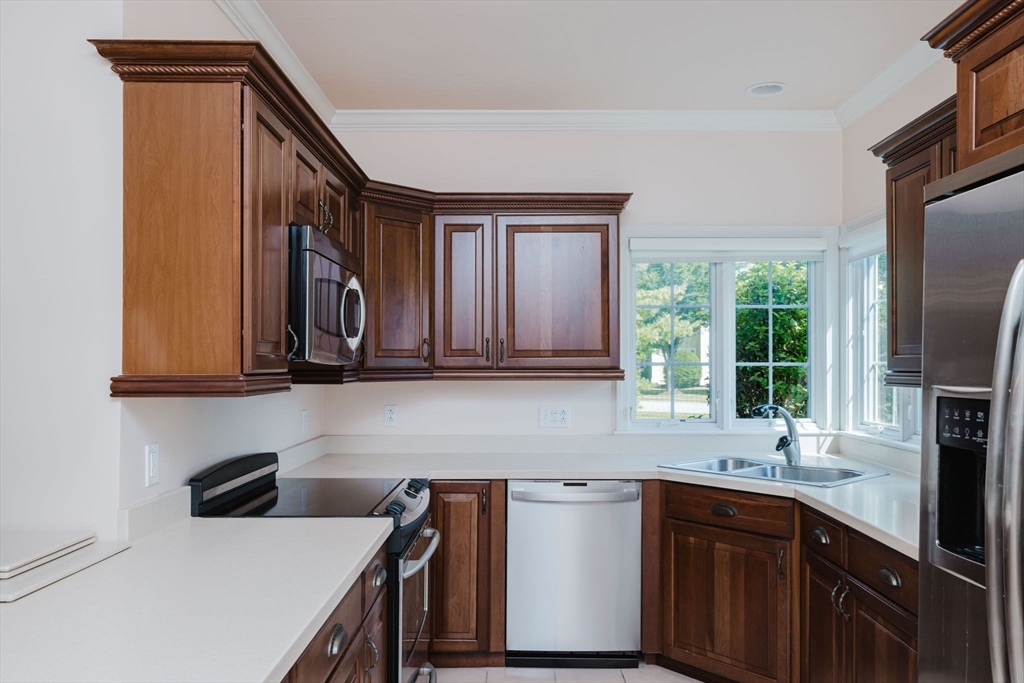 32 Village Way, Unit 32 Westport, MA 02790 - Photo 4 of 15 a kitchen with stainless steel appliances granite countertop a sink a stove and a refrigerator