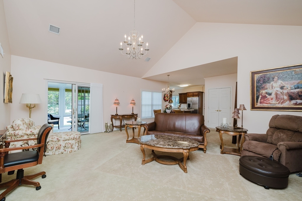 32 Village Way, Unit 32 Westport, MA 02790 - Photo 6 of 15 a living room with furniture and a chandelier