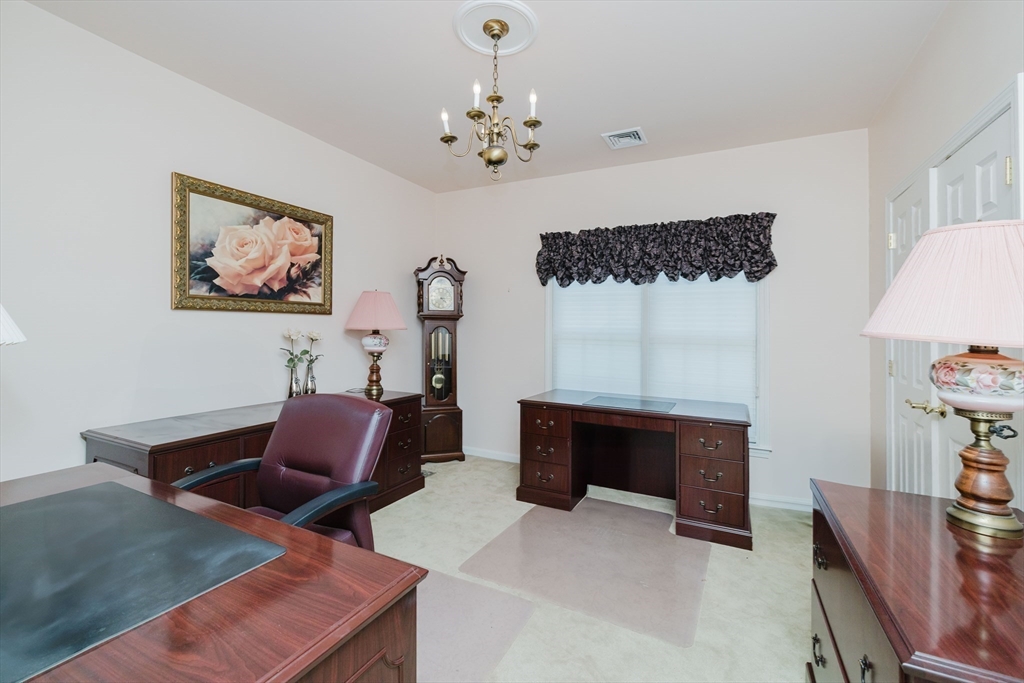 32 Village Way, Unit 32 Westport, MA 02790 - Photo 9 of 15 a living room with furniture a fireplace and a window