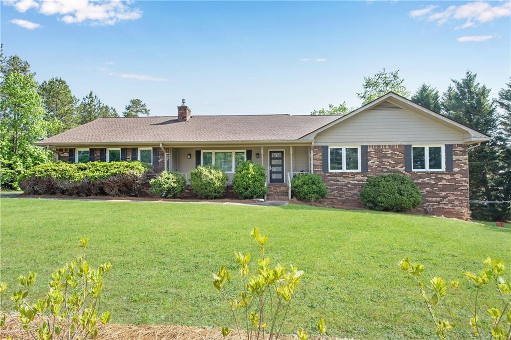 4993 West Price Road Suwanee, GA 30024 - Photo 1 of 1 a front view of a house with a yard