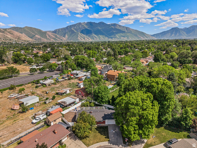 480 North 150 E Street Springville, UT 84663 - Photo 4 of 36 Aerial perspective showcasing a residential area with extensive tree coverage and distant mountain ranges