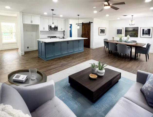 a living room with furniture kitchen view and a chandelier