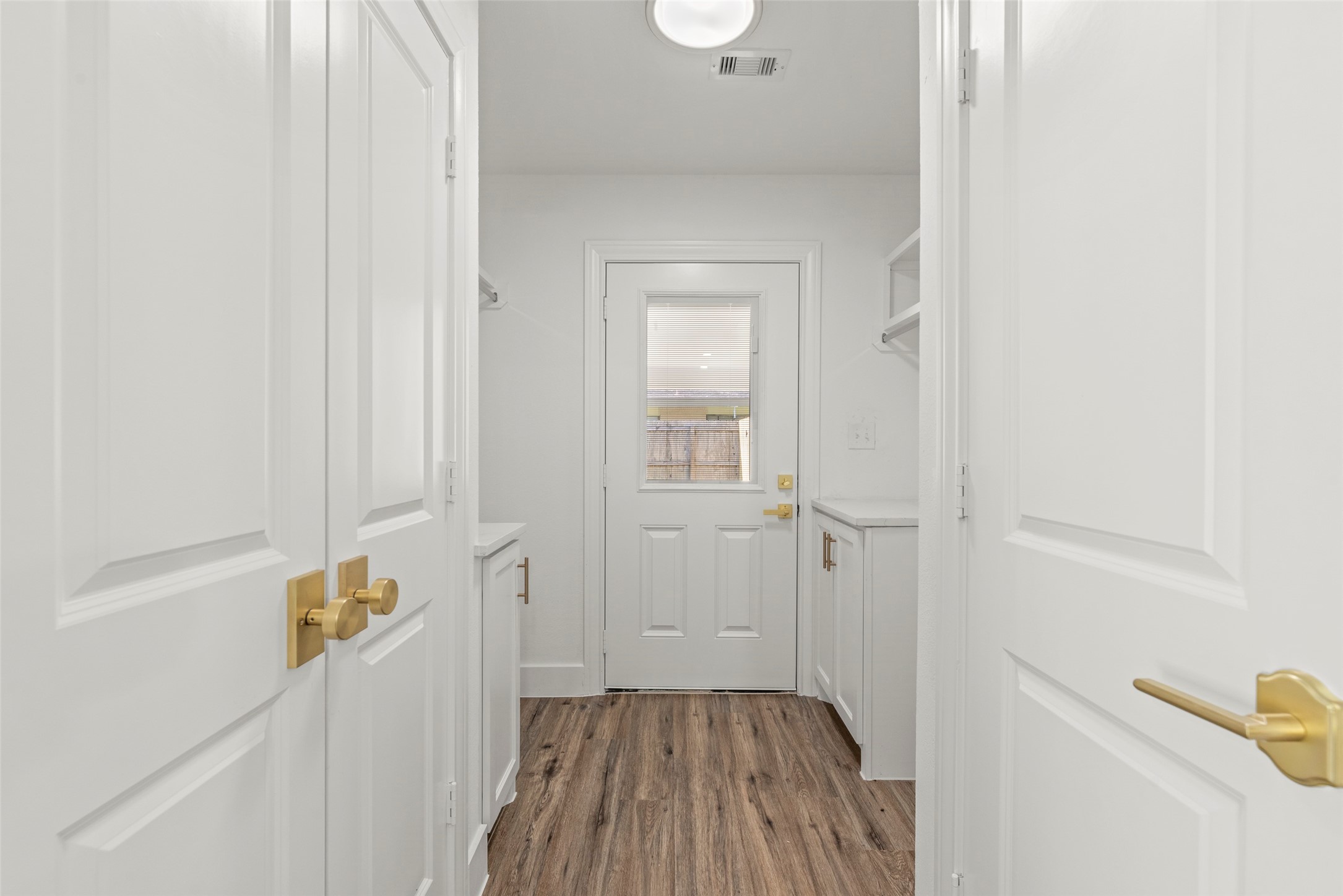 126 Daisy Street Lake Jackson, TX 77566 - Photo 11 of 36 a view of a hallway with wooden floor and staircase