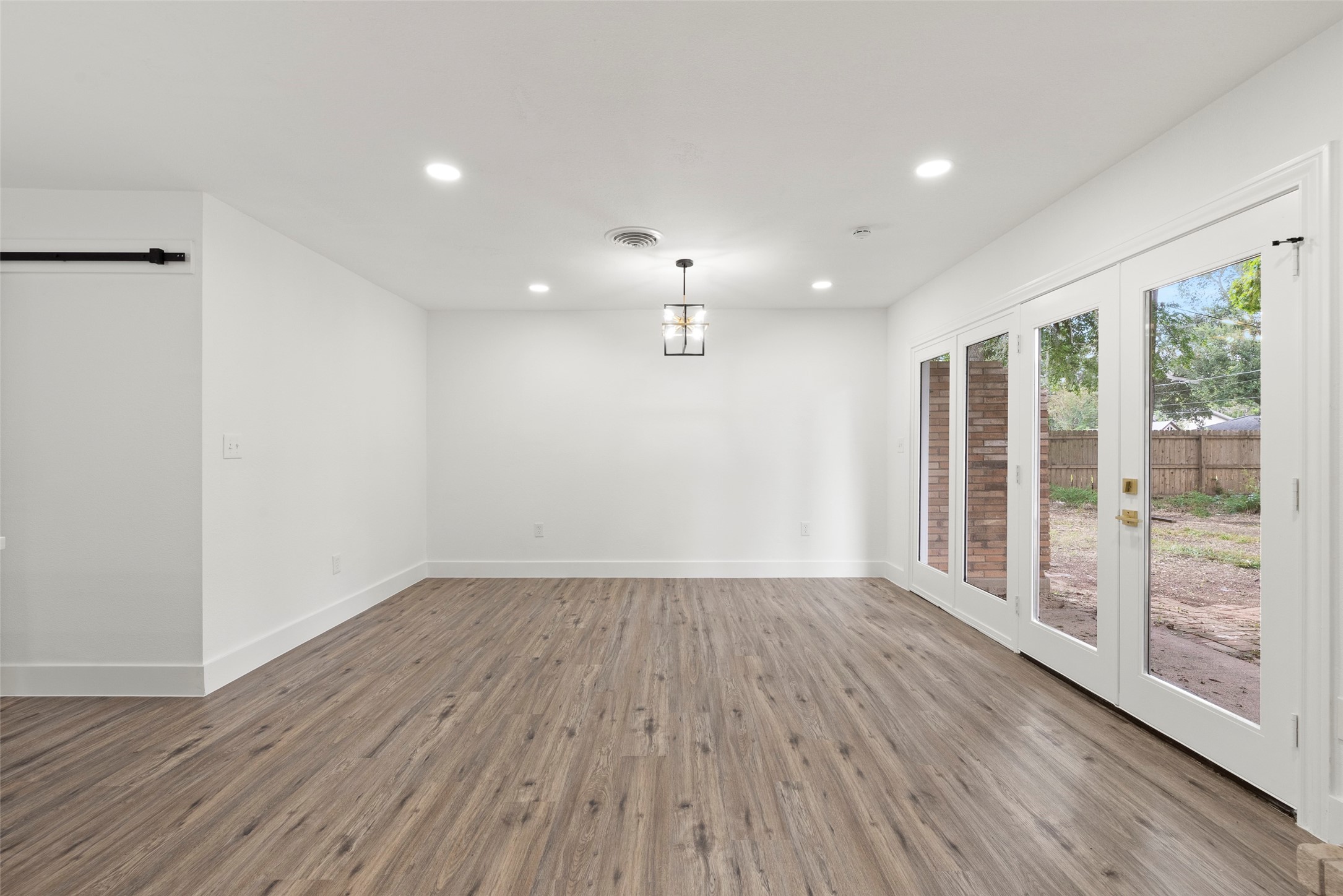 126 Daisy Street Lake Jackson, TX 77566 - Photo 17 of 36 a view of an empty room with wooden floor and a window