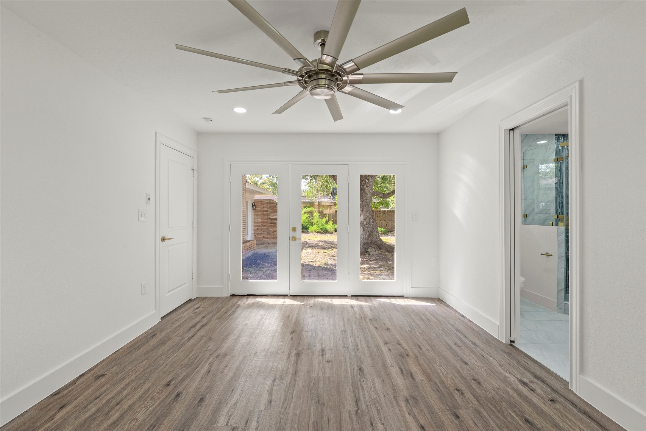 126 Daisy Street Lake Jackson, TX 77566 - Photo 20 of 36 wooden floor in an empty room with a window