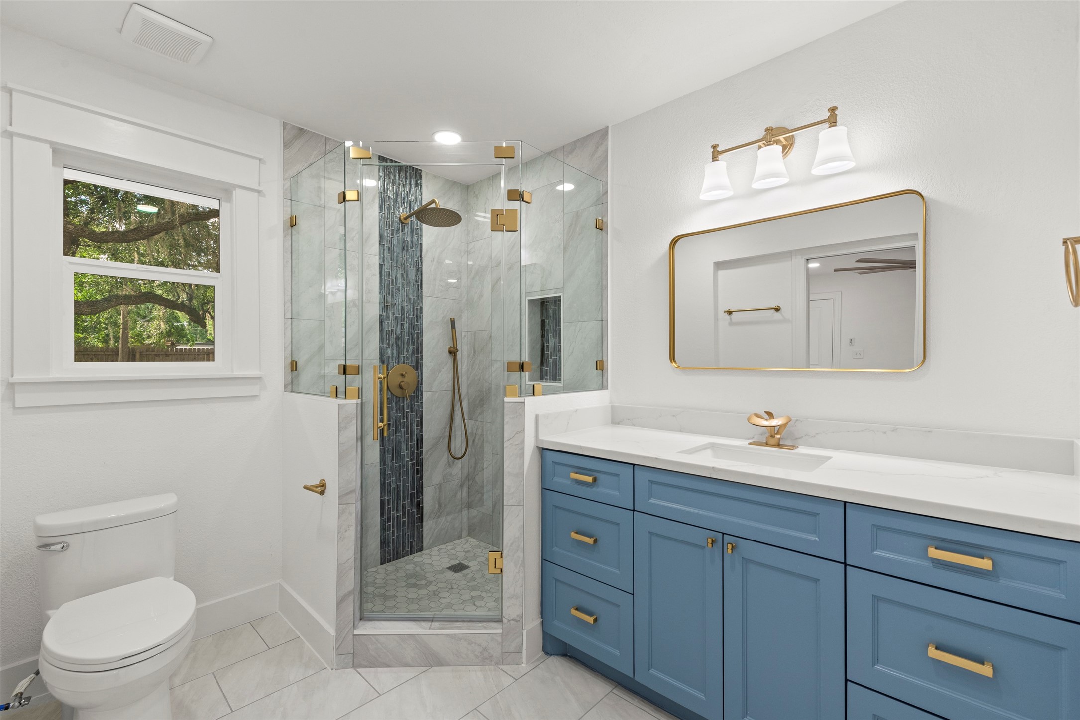 126 Daisy Street Lake Jackson, TX 77566 - Photo 21 of 36 a bathroom with a toilet a sink a mirror a shower a vanity and window