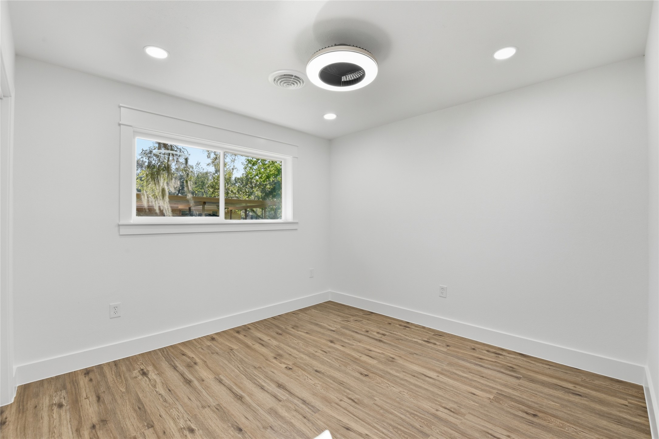 126 Daisy Street Lake Jackson, TX 77566 - Photo 28 of 36 wooden floor in an empty room with a window