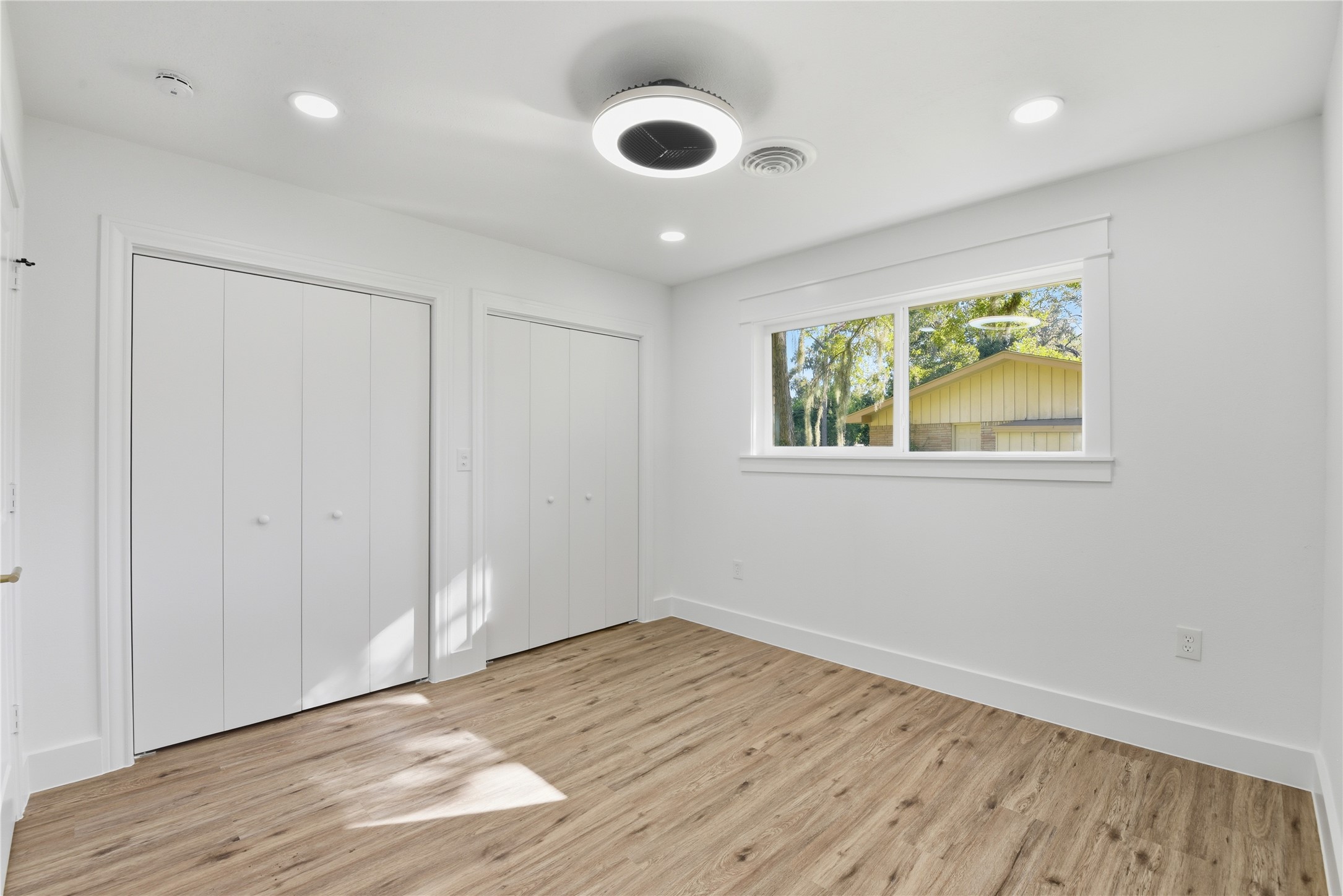 126 Daisy Street Lake Jackson, TX 77566 - Photo 29 of 36 an empty room with wooden floor and windows