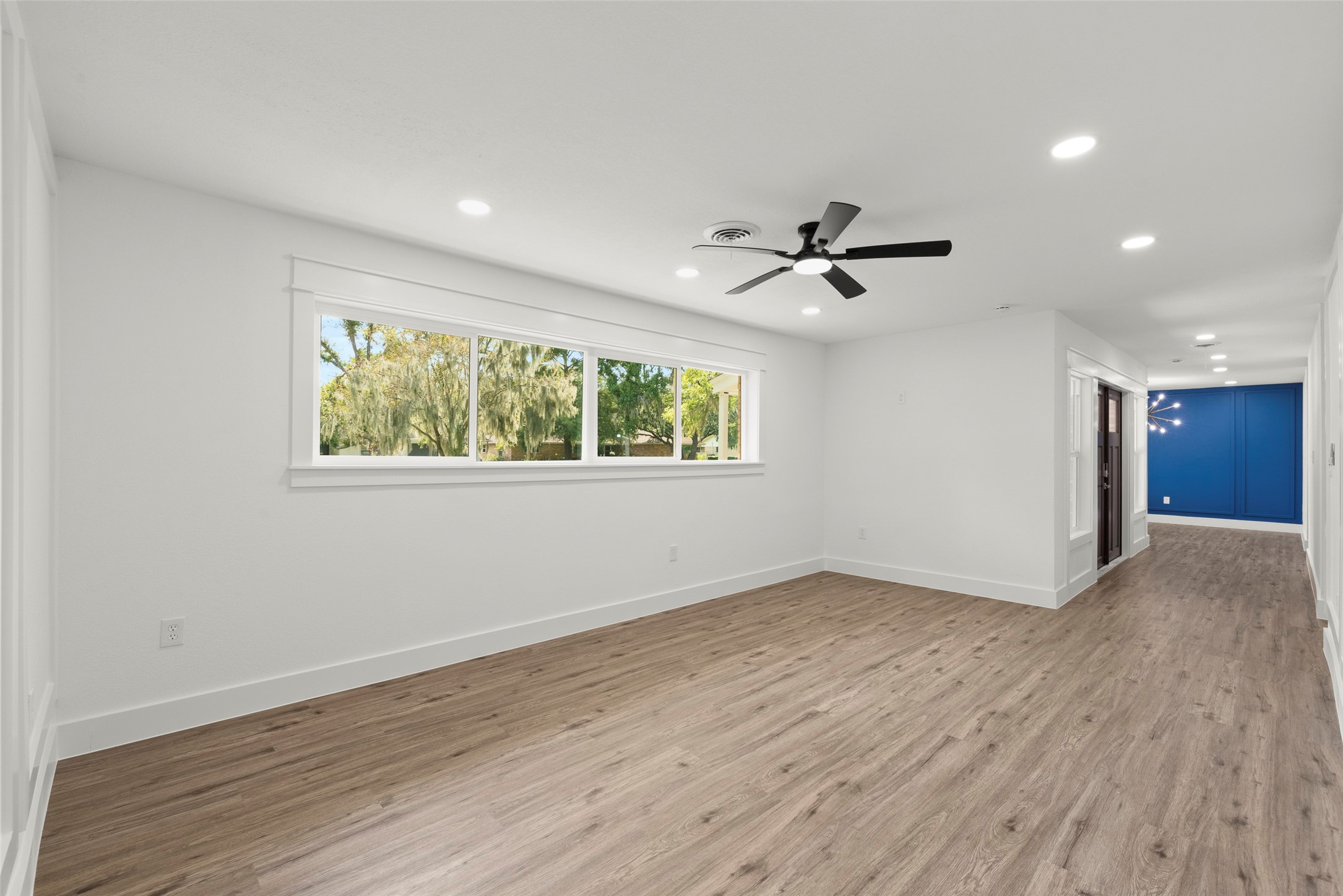 126 Daisy Street Lake Jackson, TX 77566 - Photo 8 of 36 wooden floor in an empty room with a window