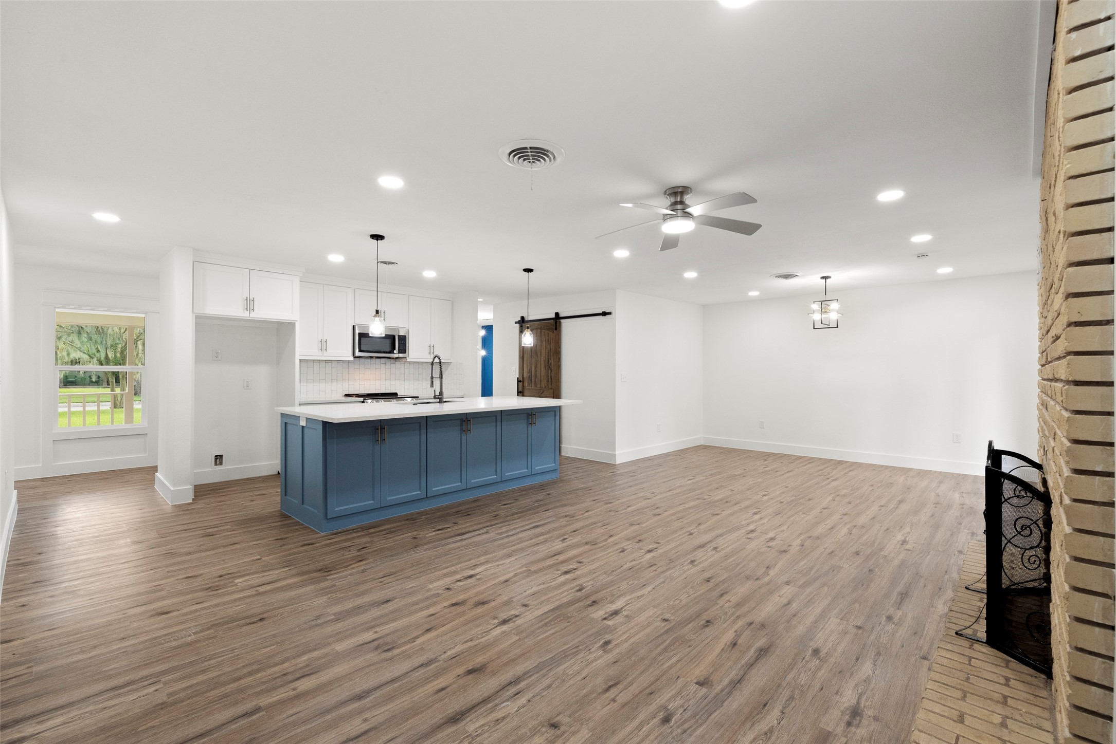 126 Daisy Street Lake Jackson, TX 77566 - Photo 9 of 36 a view of kitchen with kitchen island wooden floor and center island