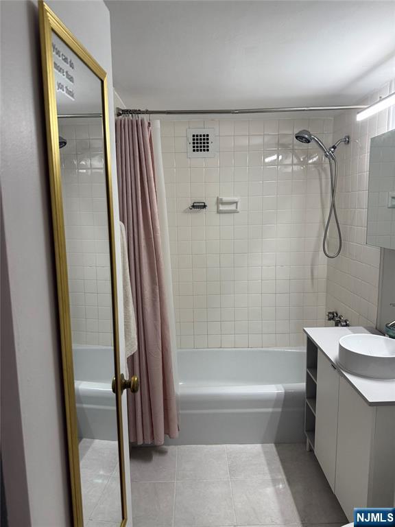 265 Main Street, Unit 702 Ridgefield Park, NJ 07660 - Photo 18 of 20 a bathroom with a bathtub a sink and a shower