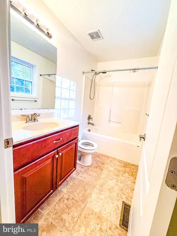 a bath room with a sink a toilet and a shower