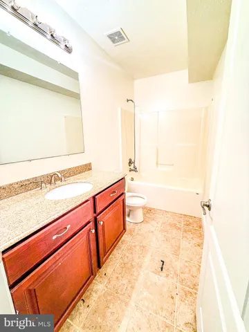 a bathroom with a tub sink and a mirror