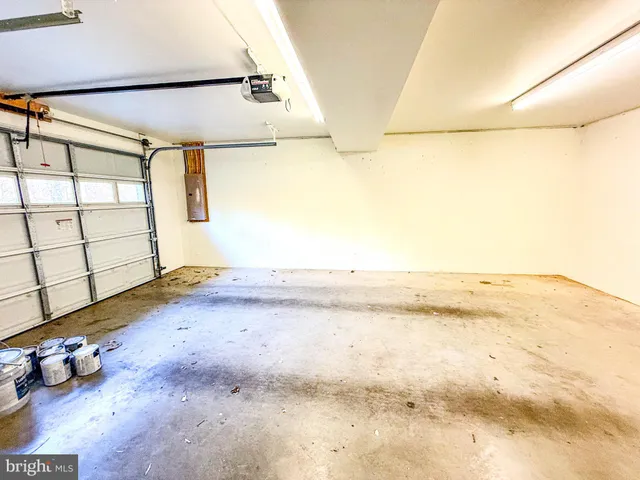 a view of a room with wooden floor and windows