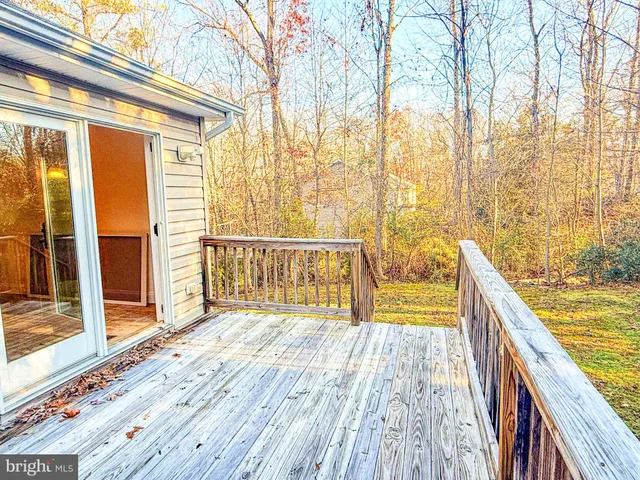 a view of balcony with wooden floor and fence