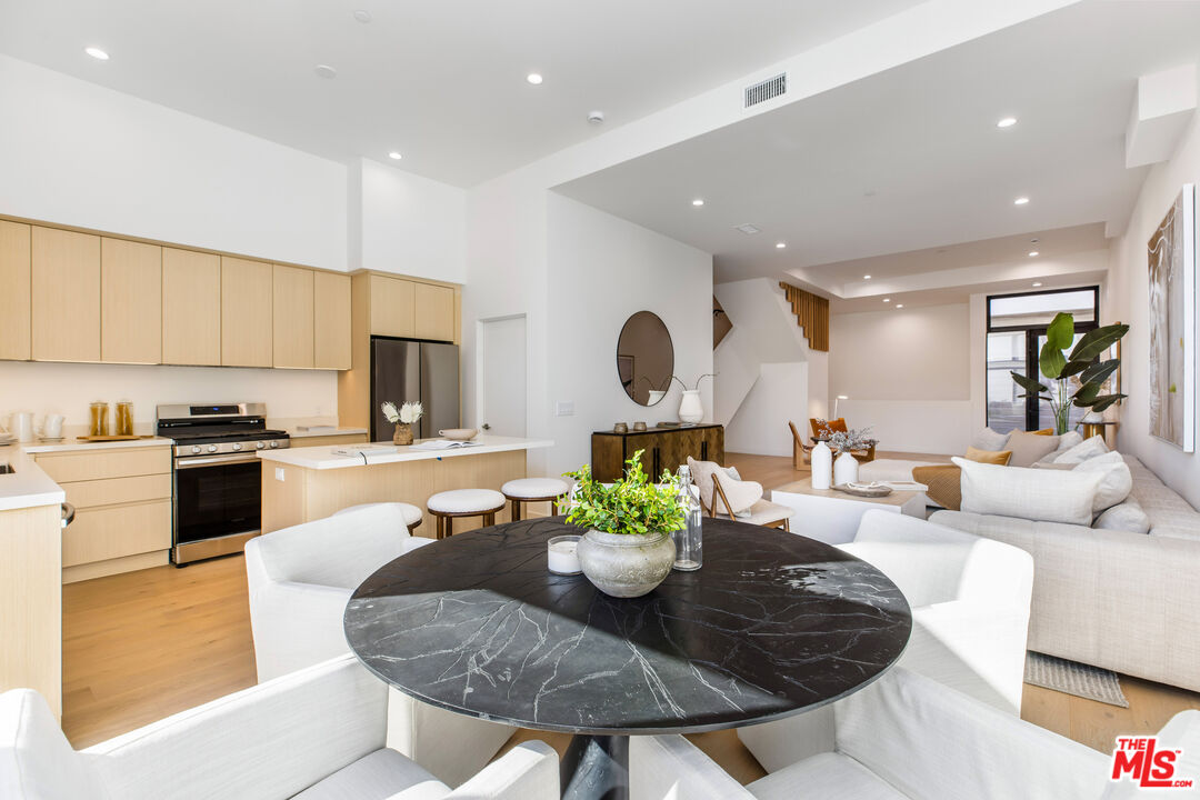 3808 College Avenue, Unit 2 Culver City, CA 90232 - Photo 4 of 15 a living room with kitchen island furniture and a view of kitchen