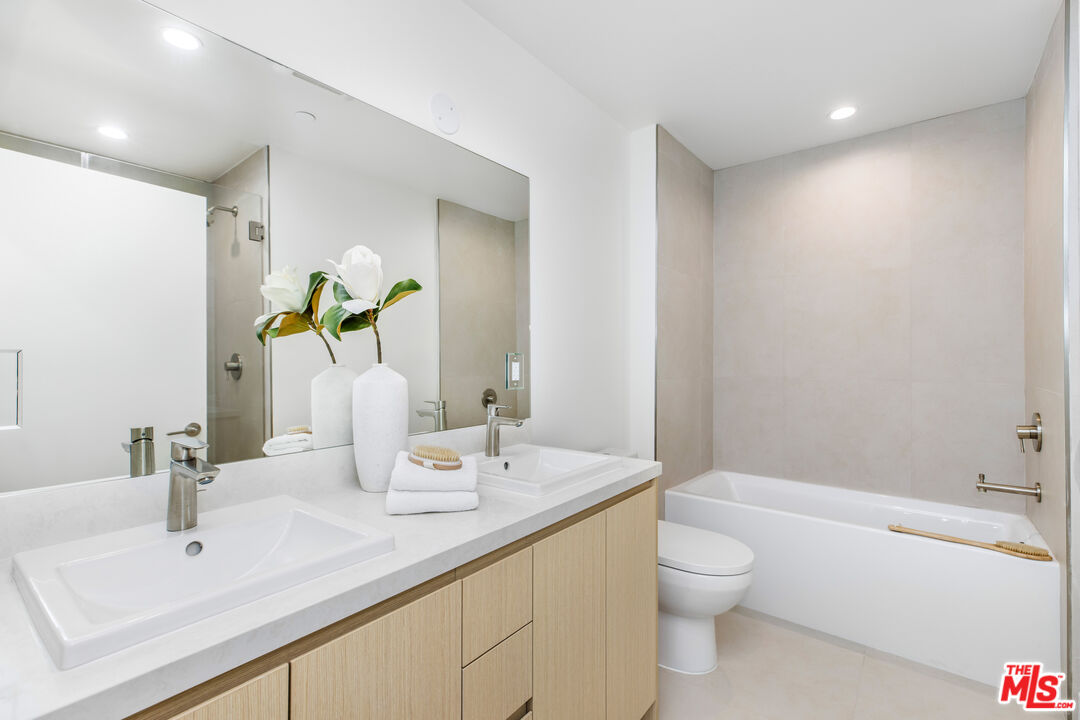 3808 College Avenue, Unit 2 Culver City, CA 90232 - Photo 8 of 15 a bathroom with a granite countertop sink a toilet and shower