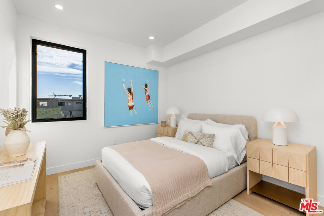 3808 College Avenue, Unit 2 Culver City, CA 90232 - Photo 9 of 15 a bedroom with a bed and a painting on the wall