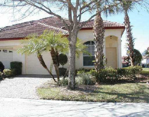 1154 Via Jardin, Unit 1154 Riviera Beach, FL 33418 - Photo 1 of 16 a front view of a house with garden