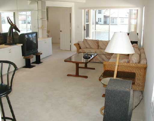 1154 Via Jardin, Unit 1154 Riviera Beach, FL 33418 - Photo 4 of 16 a living room with furniture and a window