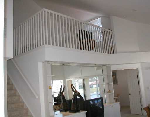 1154 Via Jardin, Unit 1154 Riviera Beach, FL 33418 - Photo 5 of 16 a view of a hallway with staircase